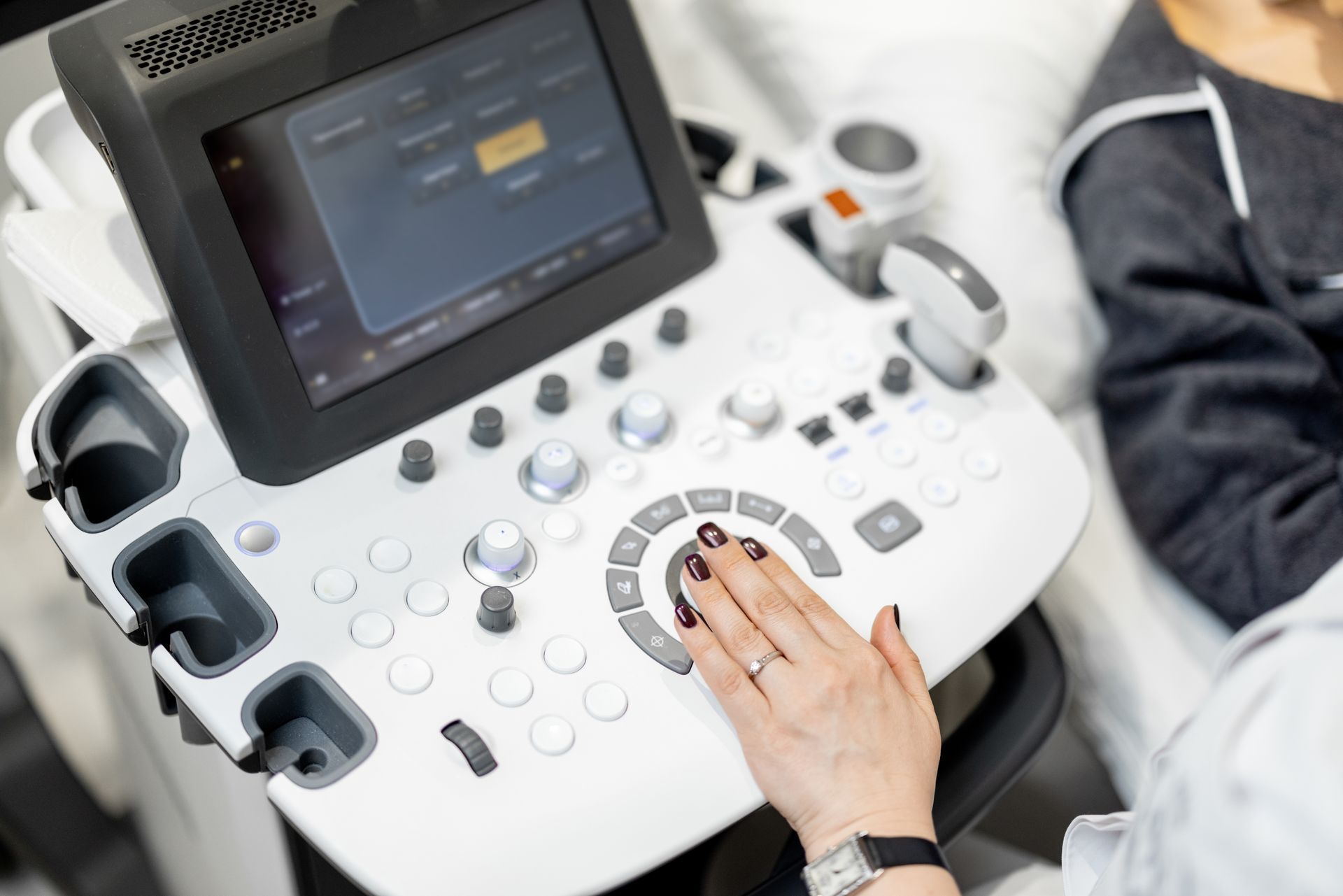 a woman is using an ultrasound machine in a hospital .