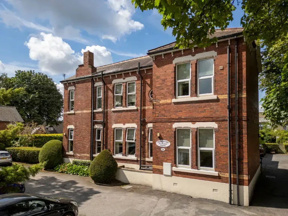 Oaklands Residential Care Home, Methley, Leeds | A large brick building with a lot of windows and a car parked in front of it.