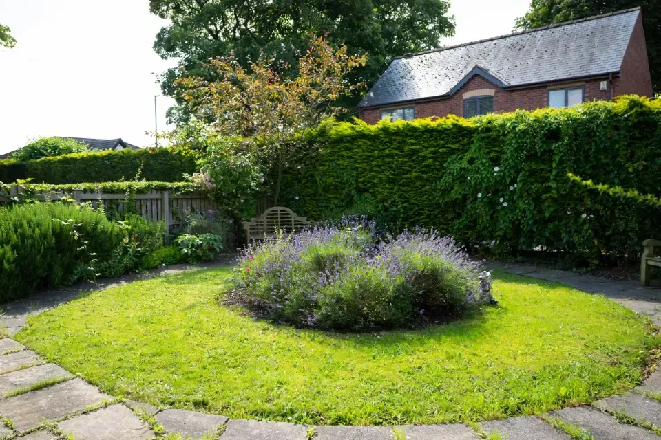 Oaklands Residential Care Home, Methley, Leeds | A garden with a circle of grass and flowers in the middle