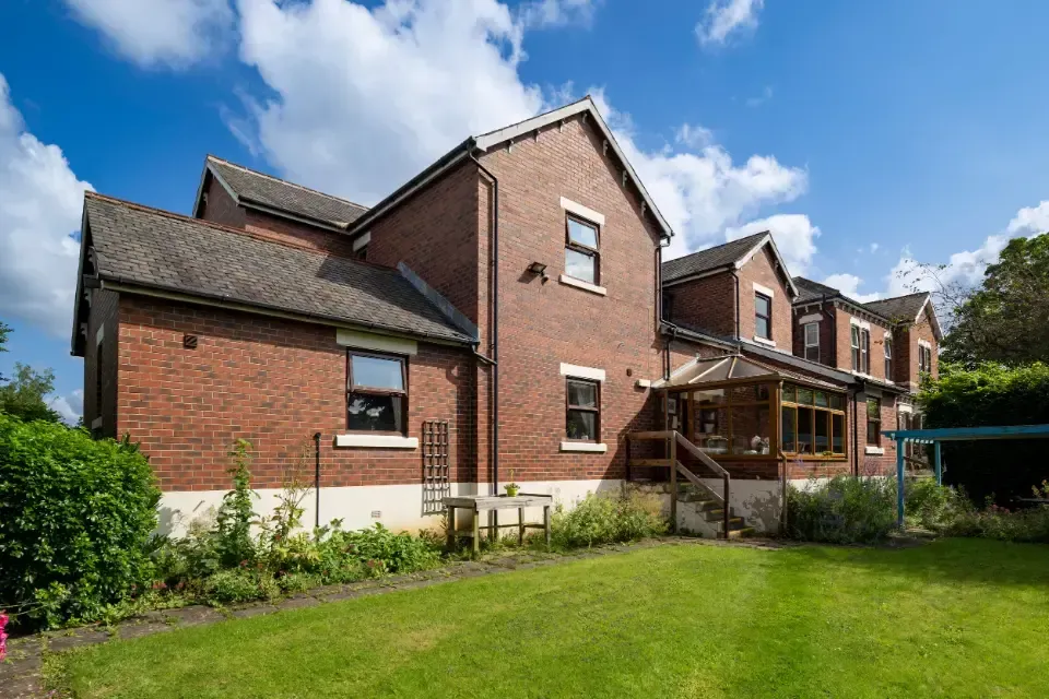 Oaklands Residential Care Home, Methley, Leeds | A large brick house with a large lawn in front of it.