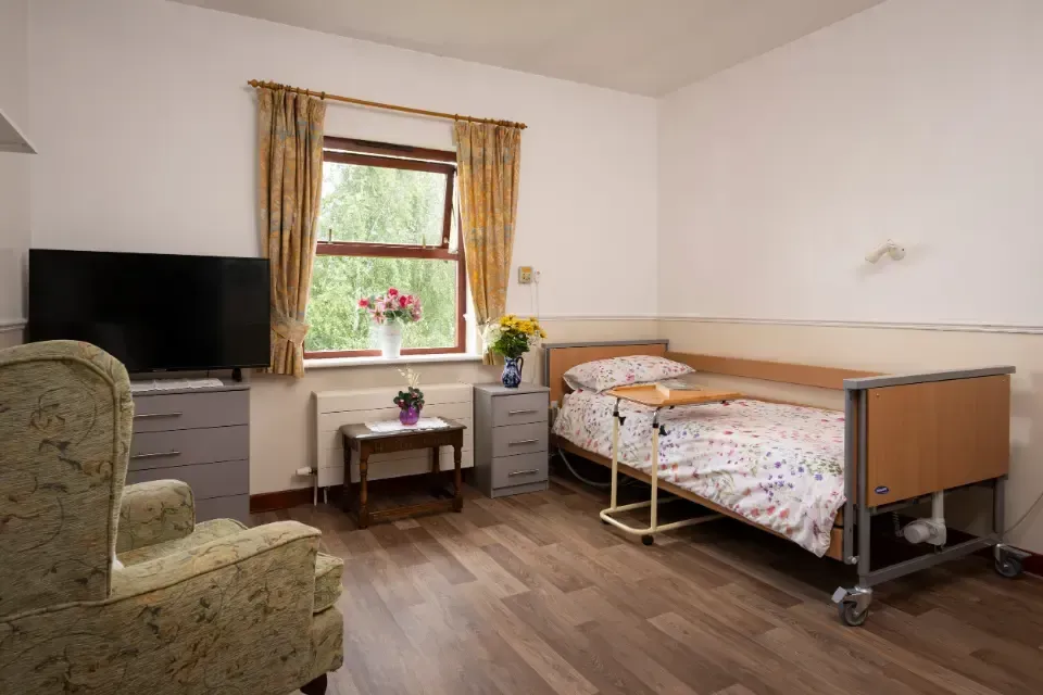 Oaklands Residential Care Home, Methley, Leeds | A bedroom with a bed , chair , television and window.