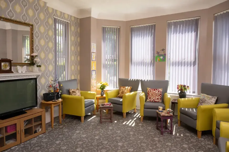 Oaklands Residential Care Home, Methley, Leeds | A living room filled with furniture and a television.