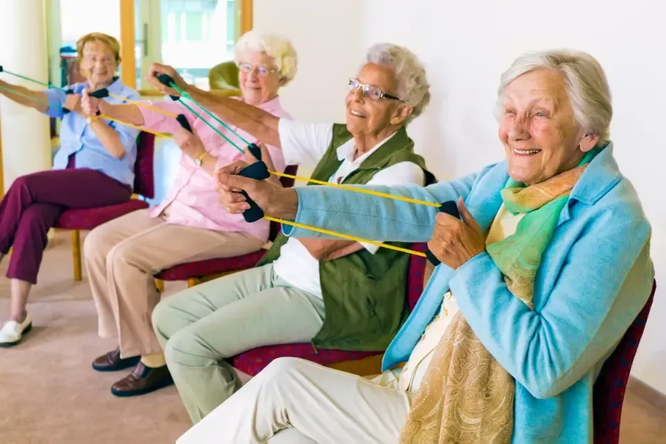 Oaklands Residential Care Home, Methley, Leeds | A group of elderly women are sitting in chairs doing exercises with resistance bands.