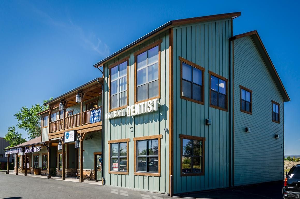 Two-story teal and wood-trimmed commercial building, 