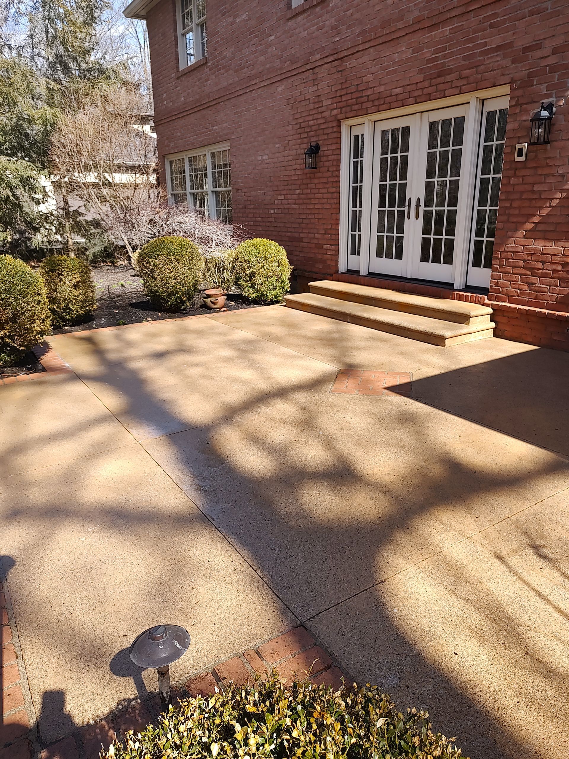 A large brick house with a patio in front of it.
