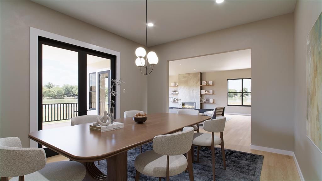 Dining room with a table, chairs, and a view of the outdoors.