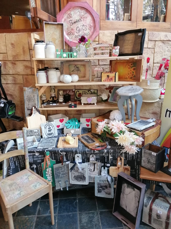 A room filled with lots of objects and a clock on a shelf.