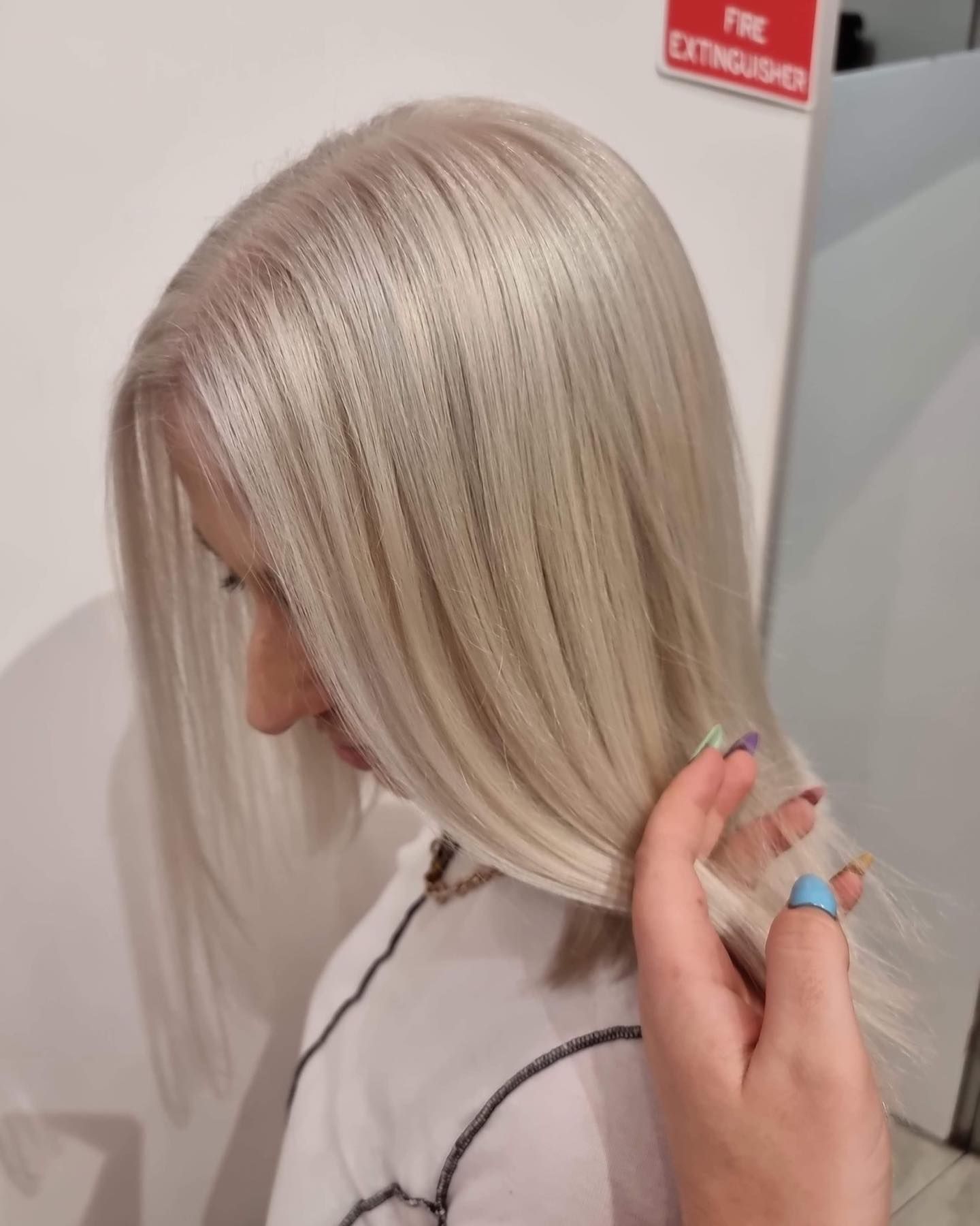 Woman With Long, Light Blonde Hair Touching Her Locks — Wow! Excellence in Hair in Toowoomba, QLD