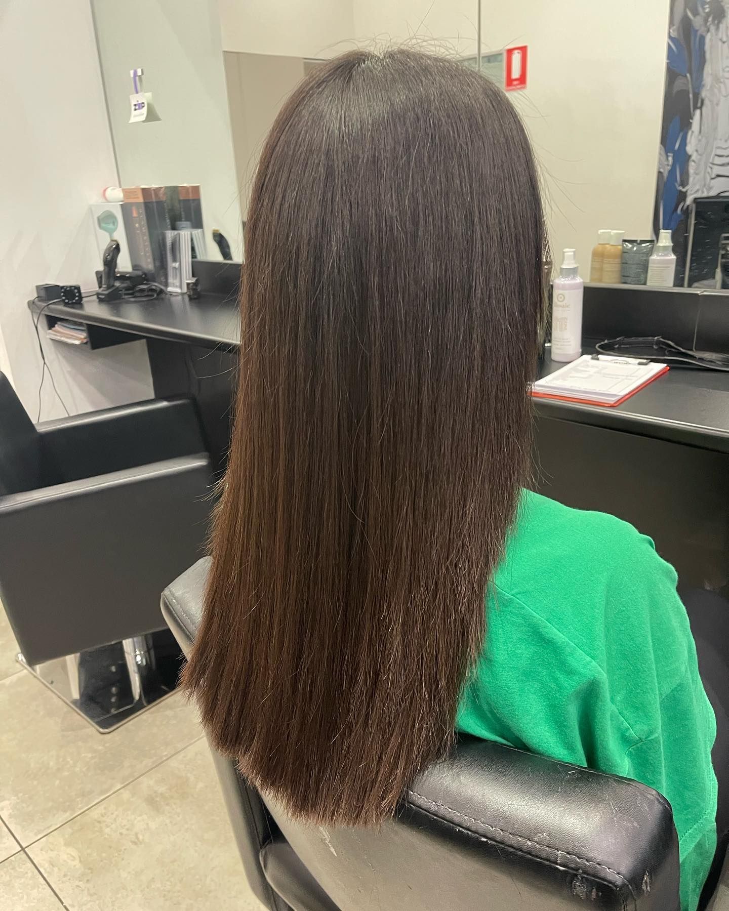 Person With Dark, Straight Hair Sits in a Salon Chair — Wow! Excellence in Hair in Toowoomba, QLD