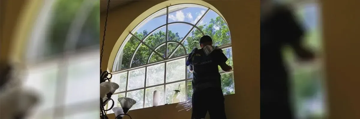 Man Cleaning Window — Miramar, FL — Oscar Tint Solutions