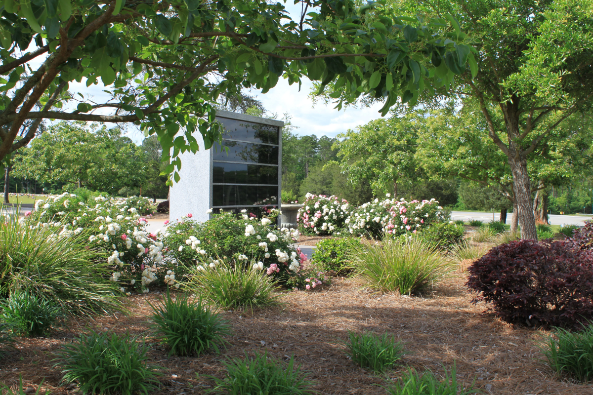 A cemetery filled with lots of graves and flowers.