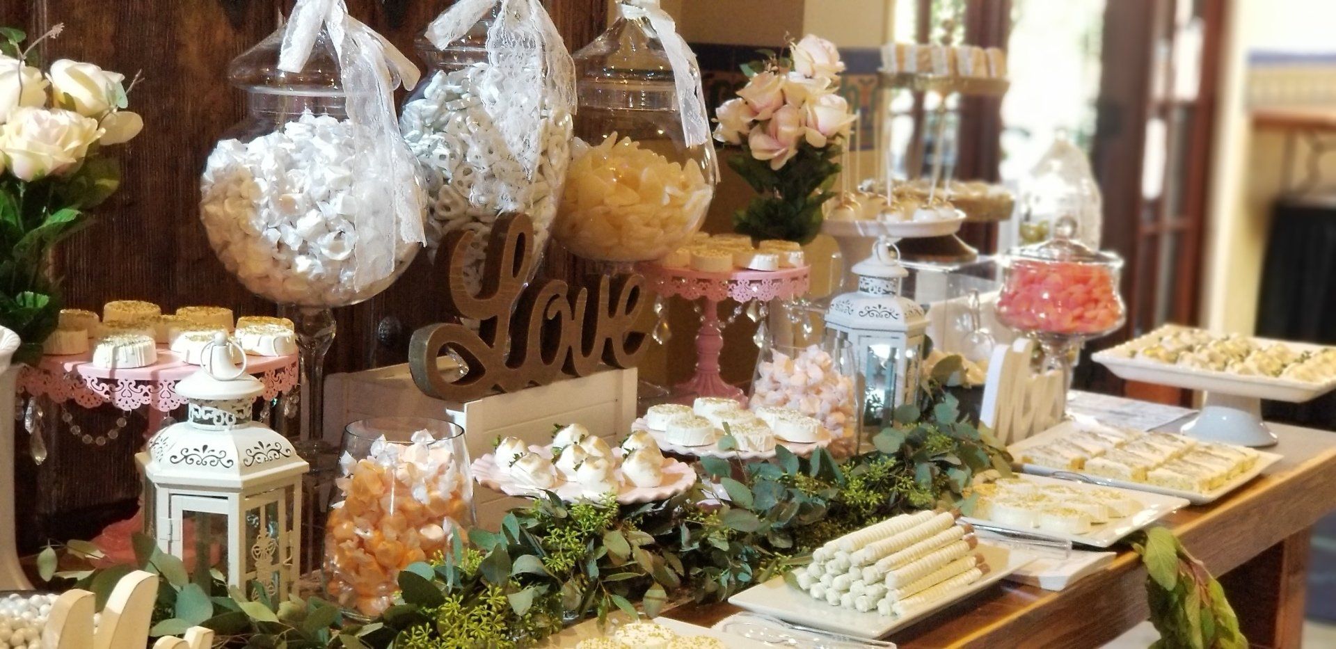 A candy bar filled with lots of candy and flowers.