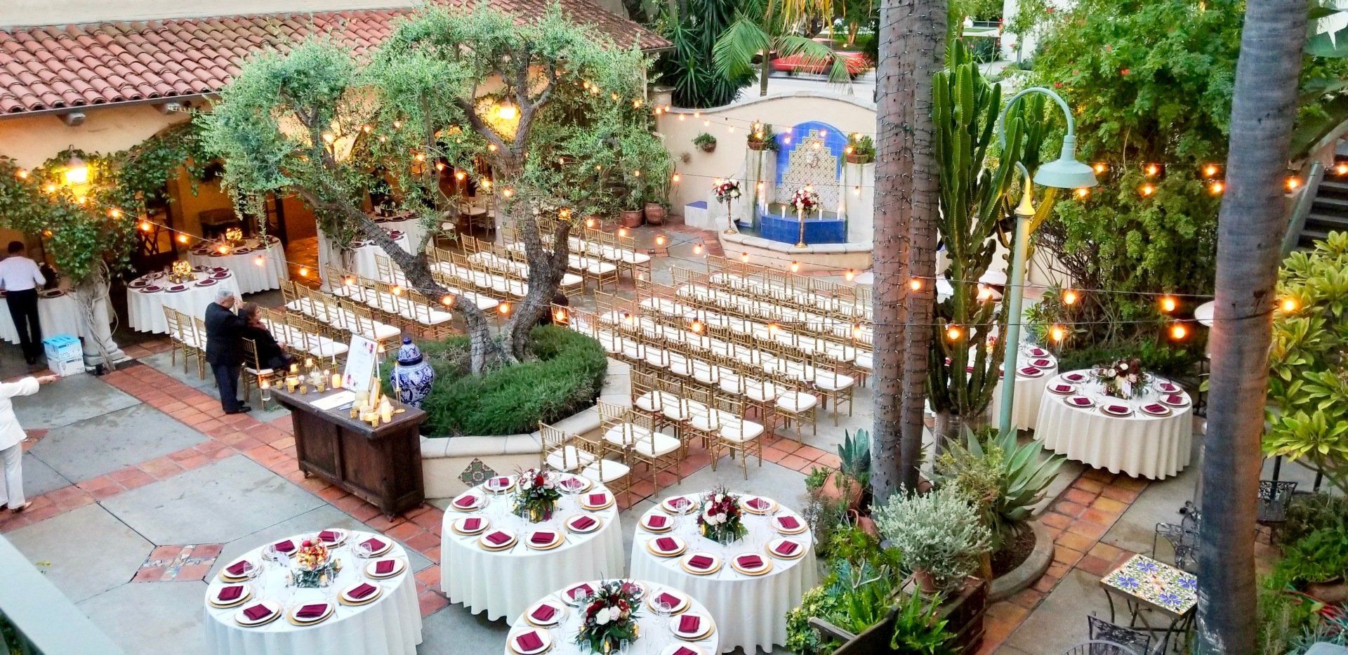 A patio with tables and chairs set up for a wedding reception.