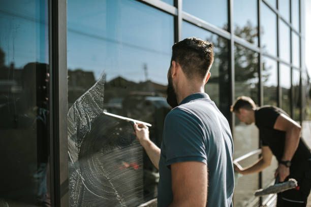 Workers Are Cleaning The Windows Of A Building — Coconut Creek, FL — American Window Washing & Pressure Inc.