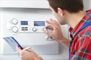 Technician servicing heating boiler - Plumbing and Heating in Winona, MN
