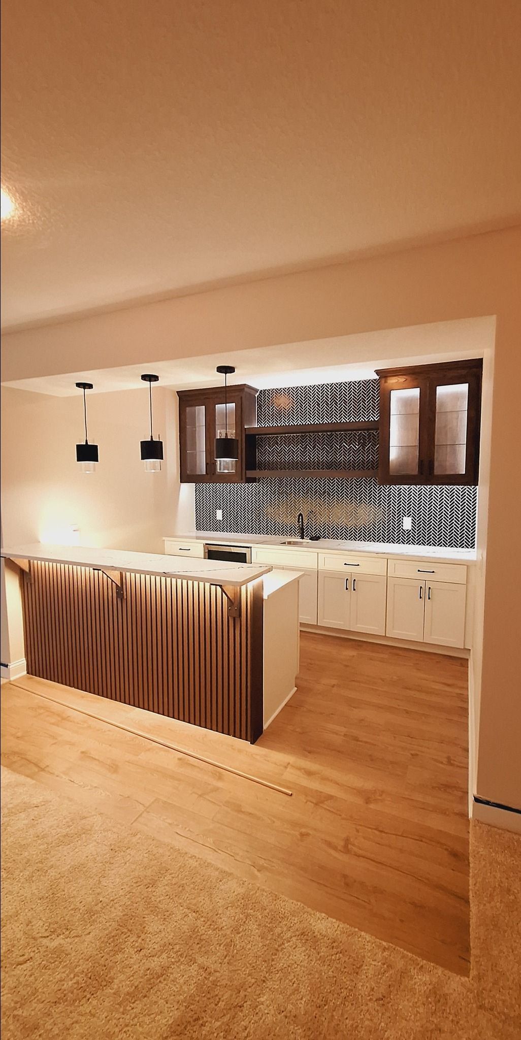 A kitchen with a large island in the middle of the room.