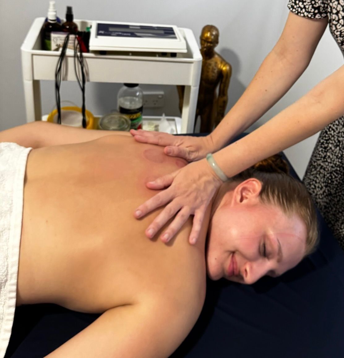 A Person Is Getting An Electrotherapy Treatment On Their Leg — Resonance Health Studio in Wauchope, NSW
