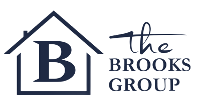 Logo for The Brooks Group, a real estate company. Features a house outline with a large 