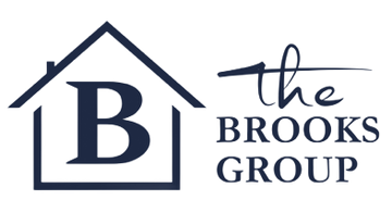Logo for The Brooks Group, a real estate company. Features a house outline with a large