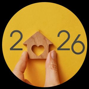 Hand holding a wooden house with a heart cutout, flanked by the numbers 