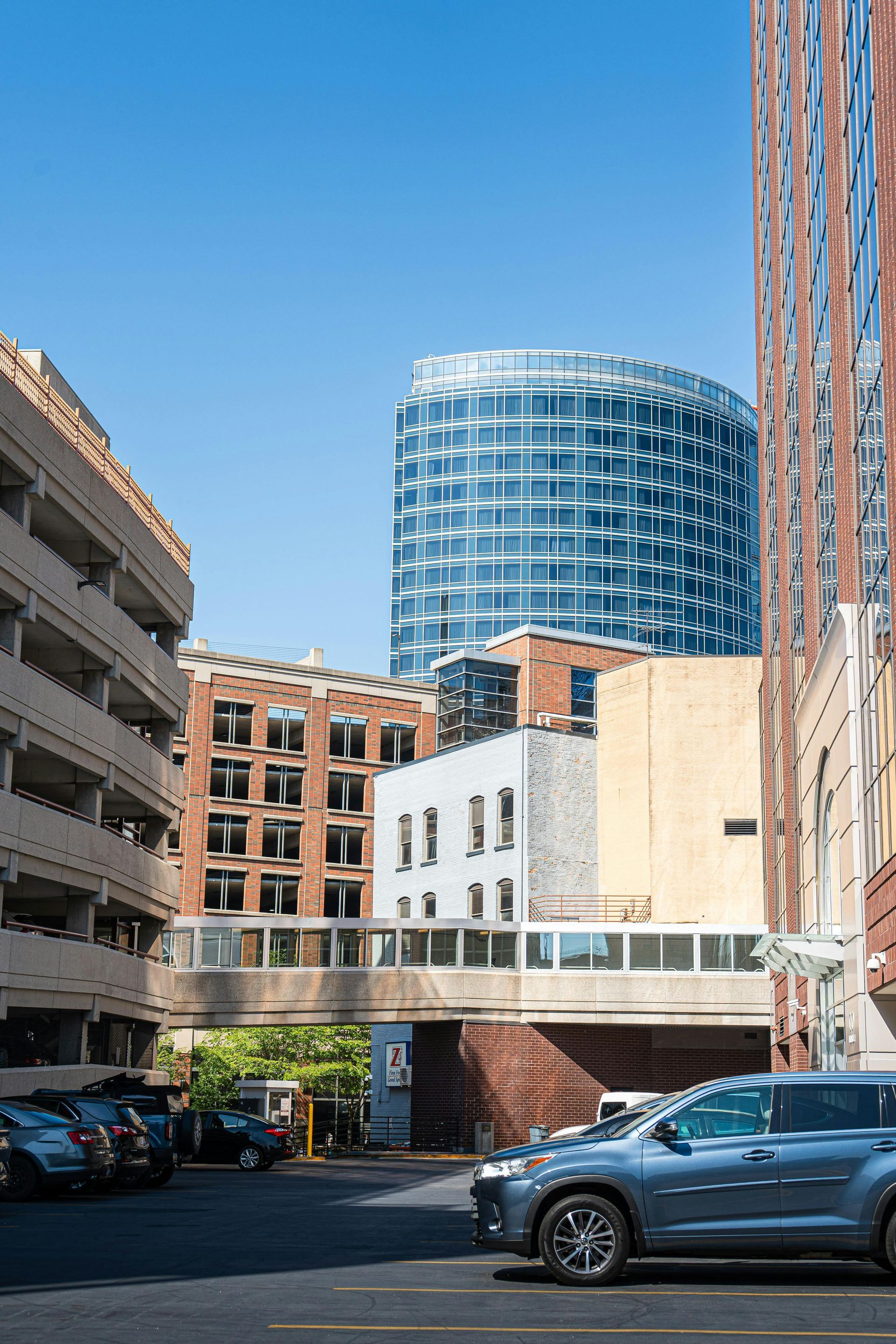 Person using calculator with paperwork, laptop, and coffee on a table.