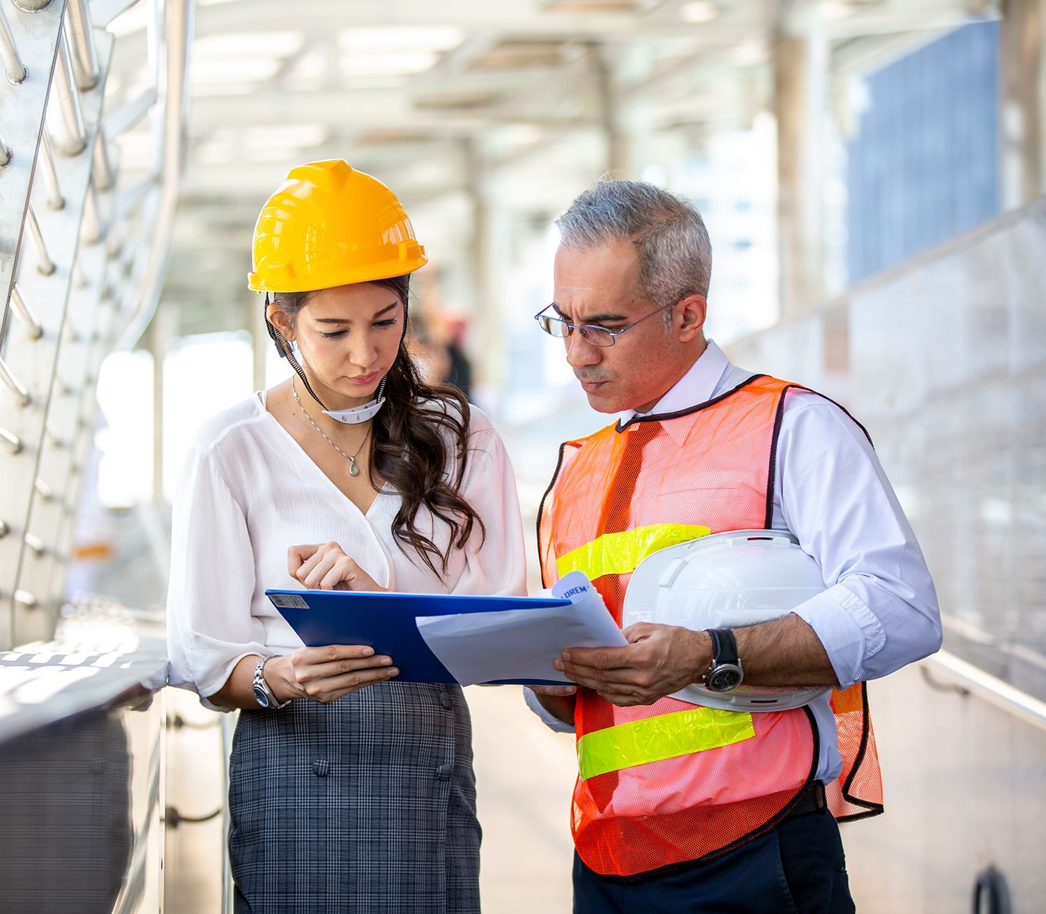 A man and a woman are looking at a clipboard. A man and a woman are looking at a clipboard.