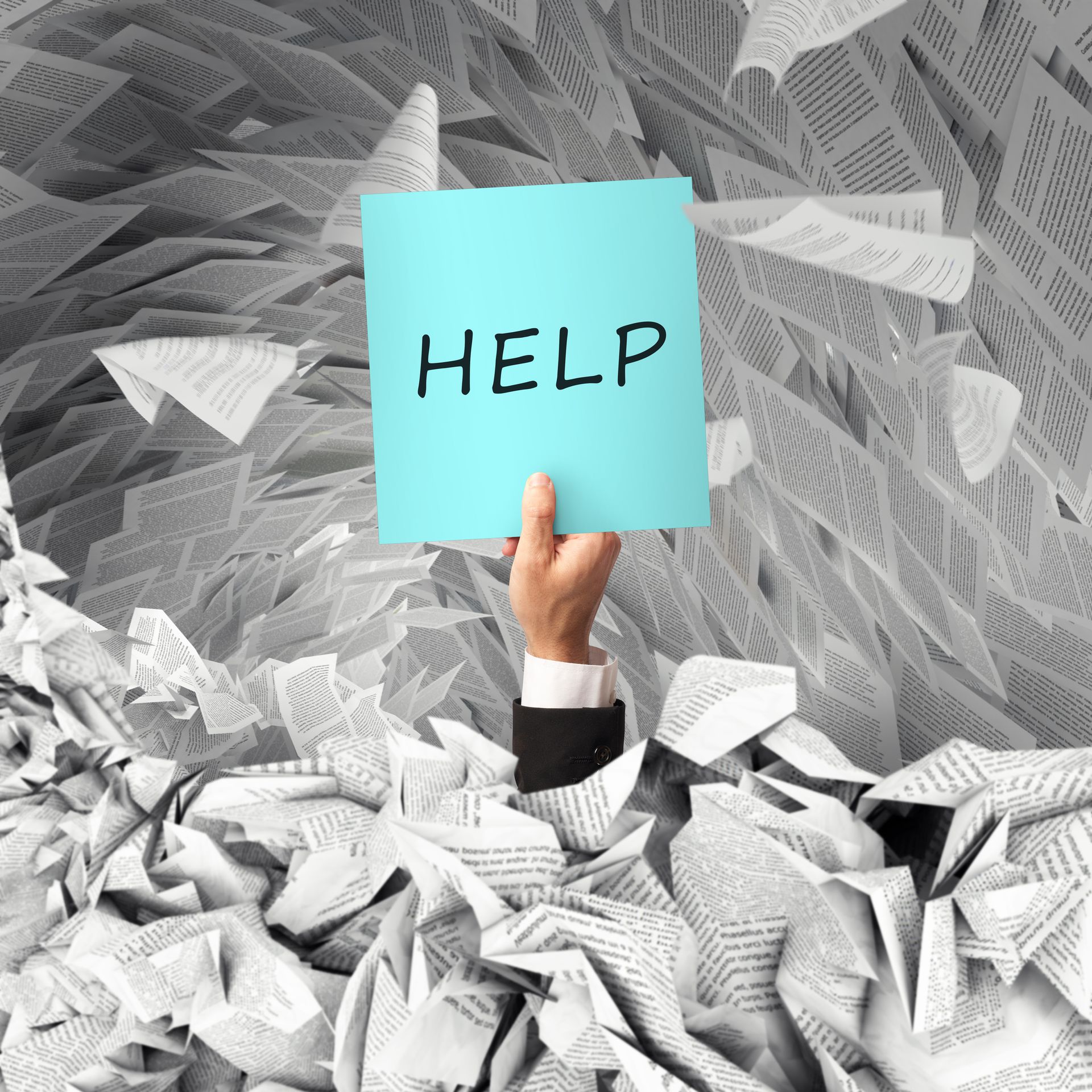 A hand is holding up a sign that says help