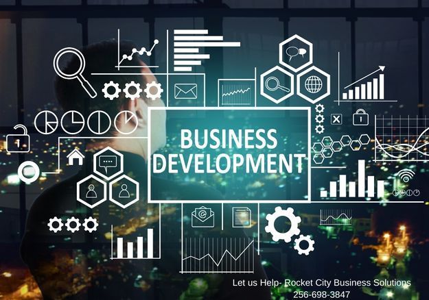 A man is looking at a screen that says business development.
