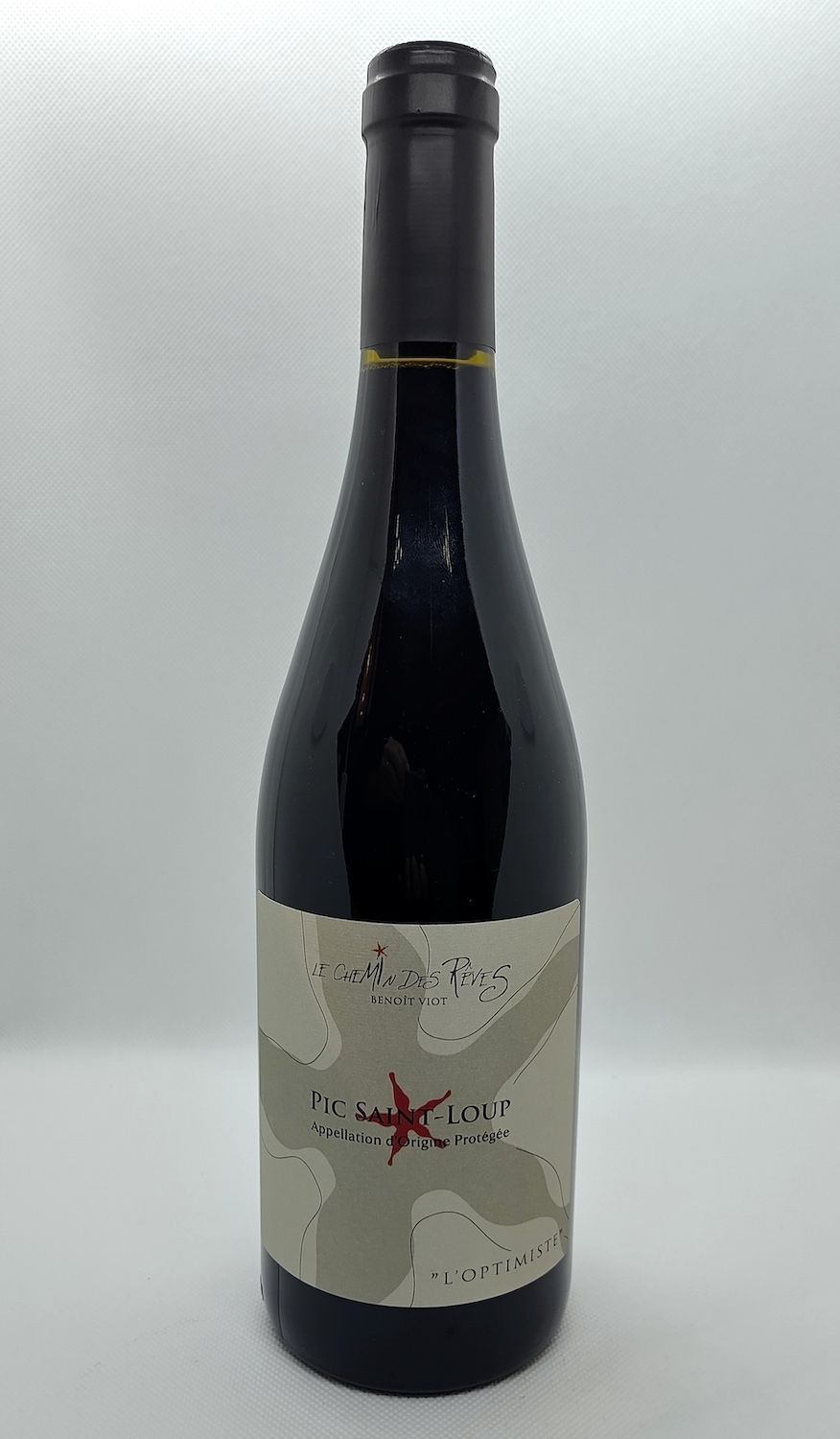 Une bouteille de vin blanc avec un oiseau sur l'étiquette sur fond blanc.