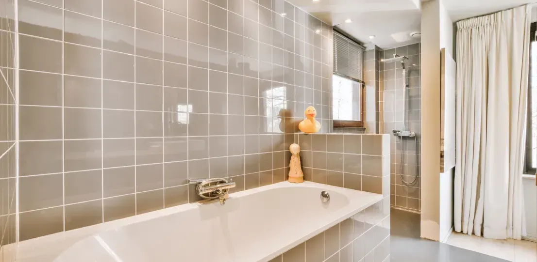 A bathroom with a bathtub and a shower.