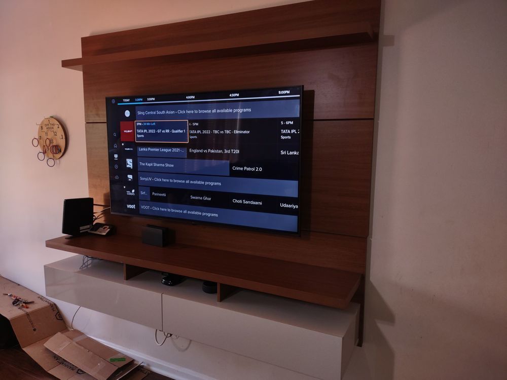 A flat screen tv is mounted on a wall in a living room
