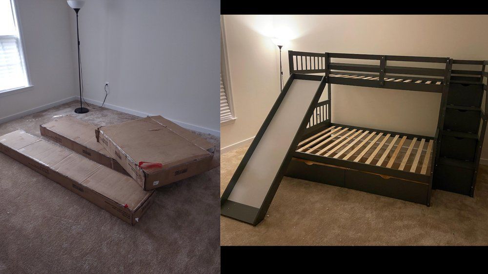 A bunk bed with a slide is sitting in a room next to a cardboard box.