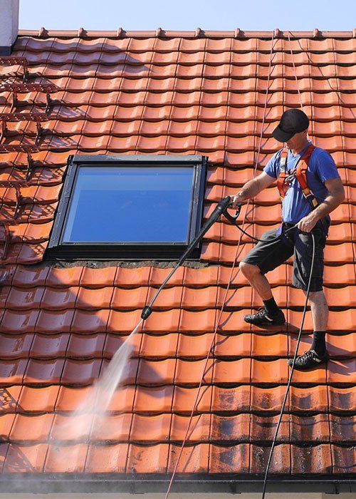A Man Cleaning The Roof — Tropical Cleaning Services in Innisfail, QLD