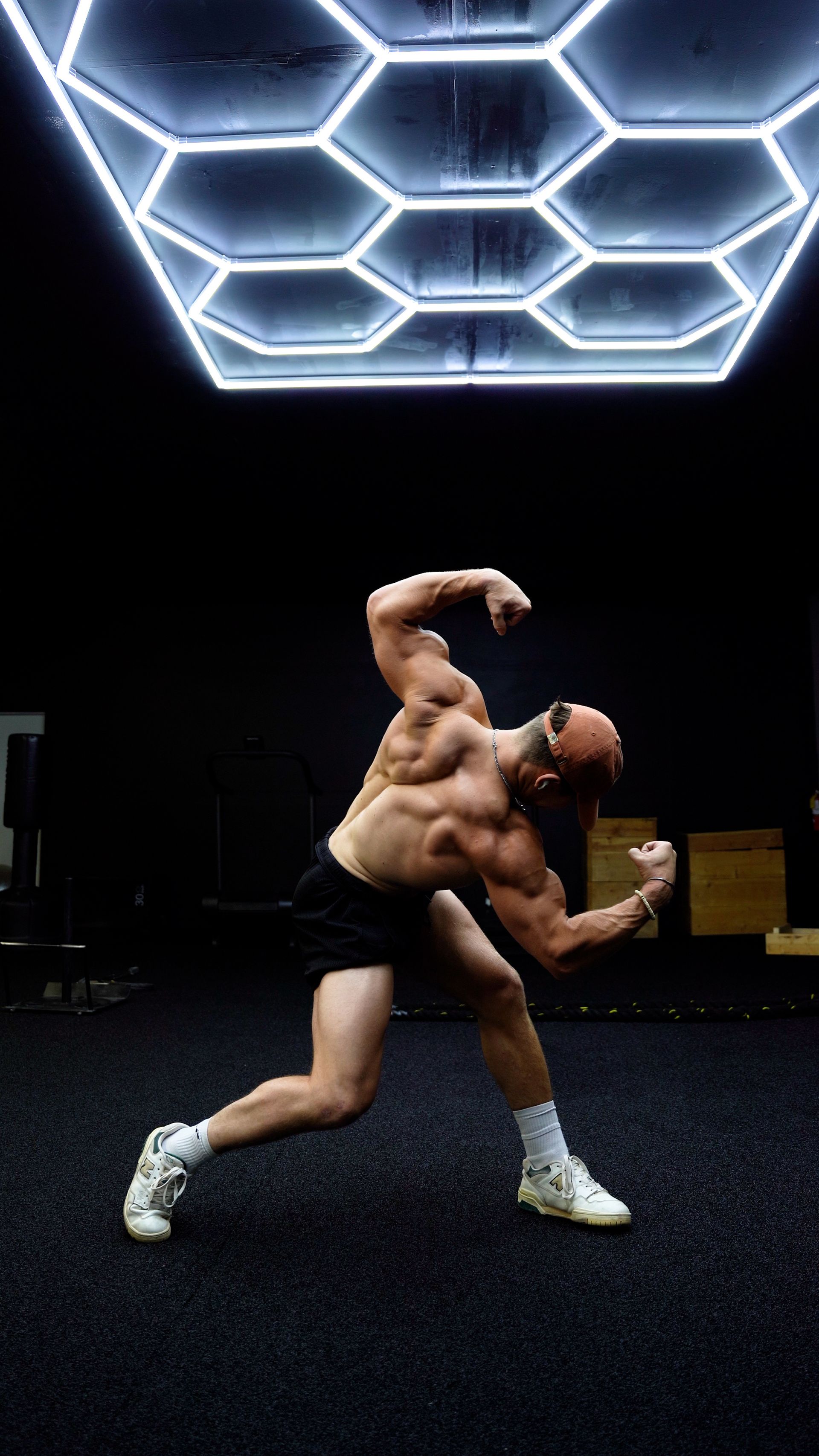 Dylan Kolak is flexing his muscles in a gym.