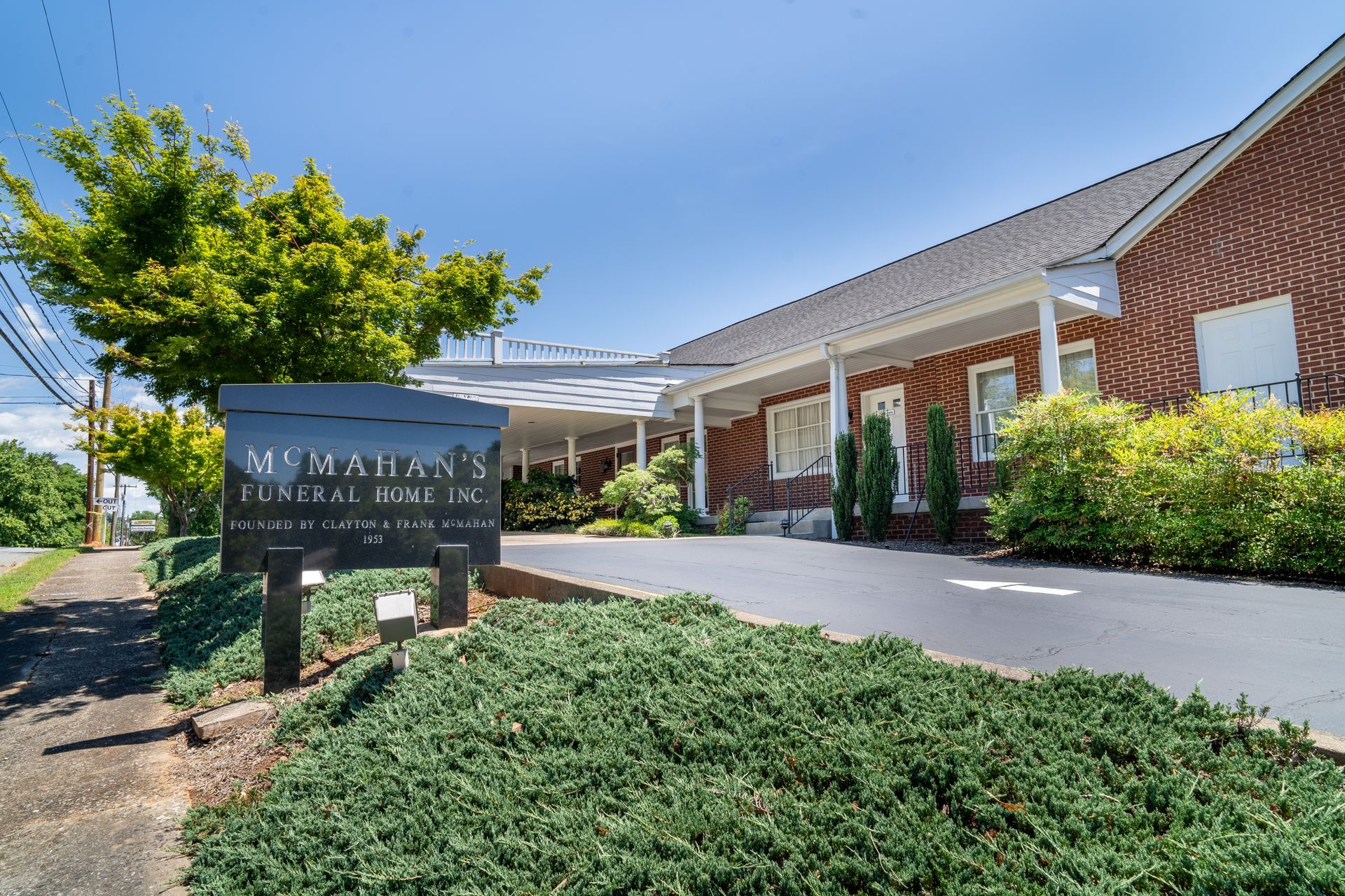 White cherry blossom branch against a blurred, overcast sky.