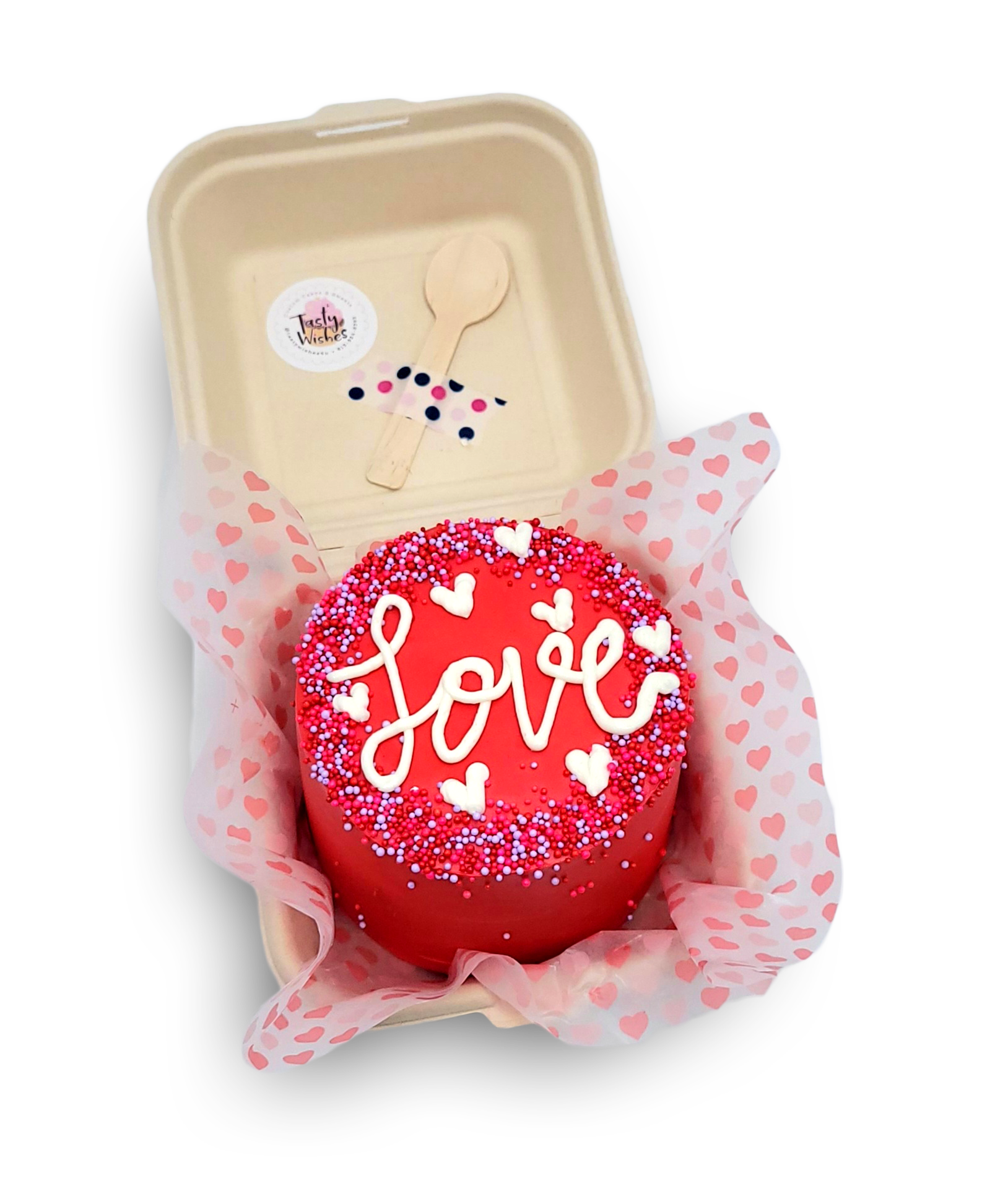 A small, round red cake with the word 