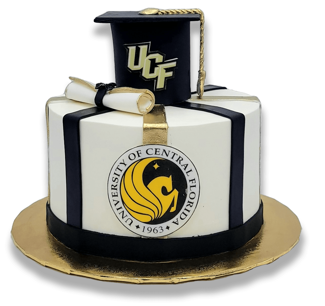 A round white graduation cake featuring a black UCF mortarboard, a diploma, and the University of Central Florida logo.