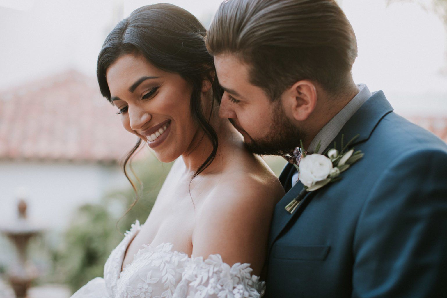 A bride and groom are posing for a picture on their wedding day.
