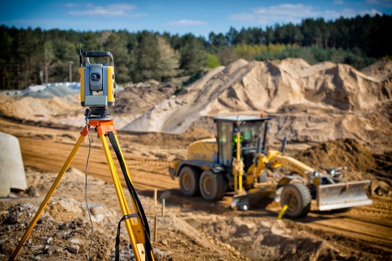 Land Surveyor Equipment On A Highway Construction Site — Floresville, TX — Polluck & Sons Surveying Inc.