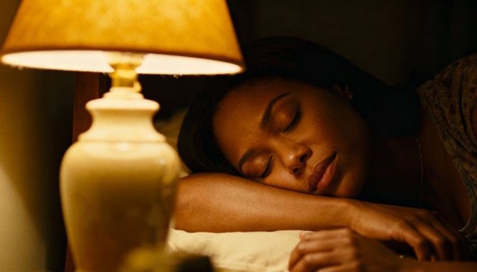 A Dayton woman peacefully sleeping beside a softly lit lamp