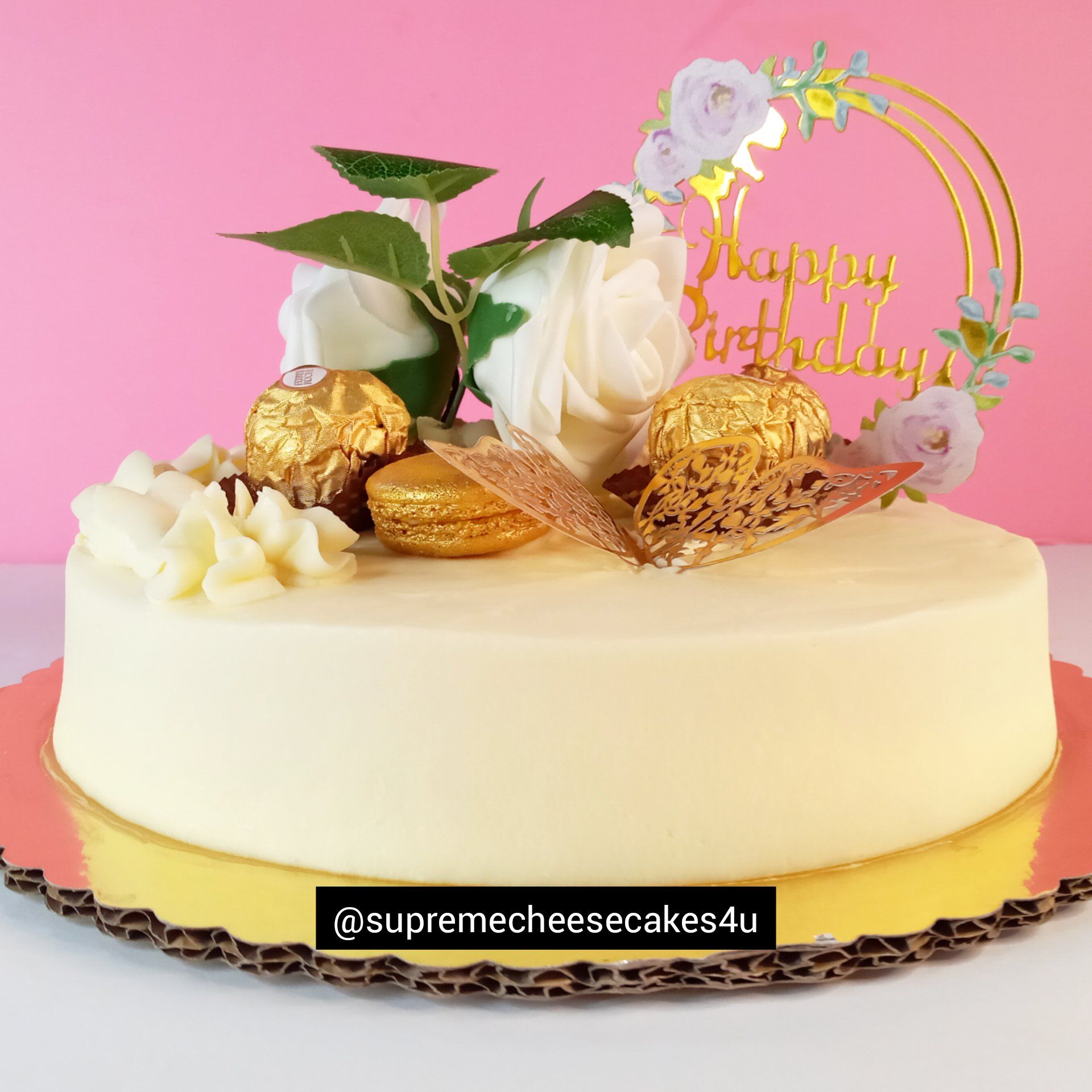 A birthday cake with flowers and a happy birthday topper