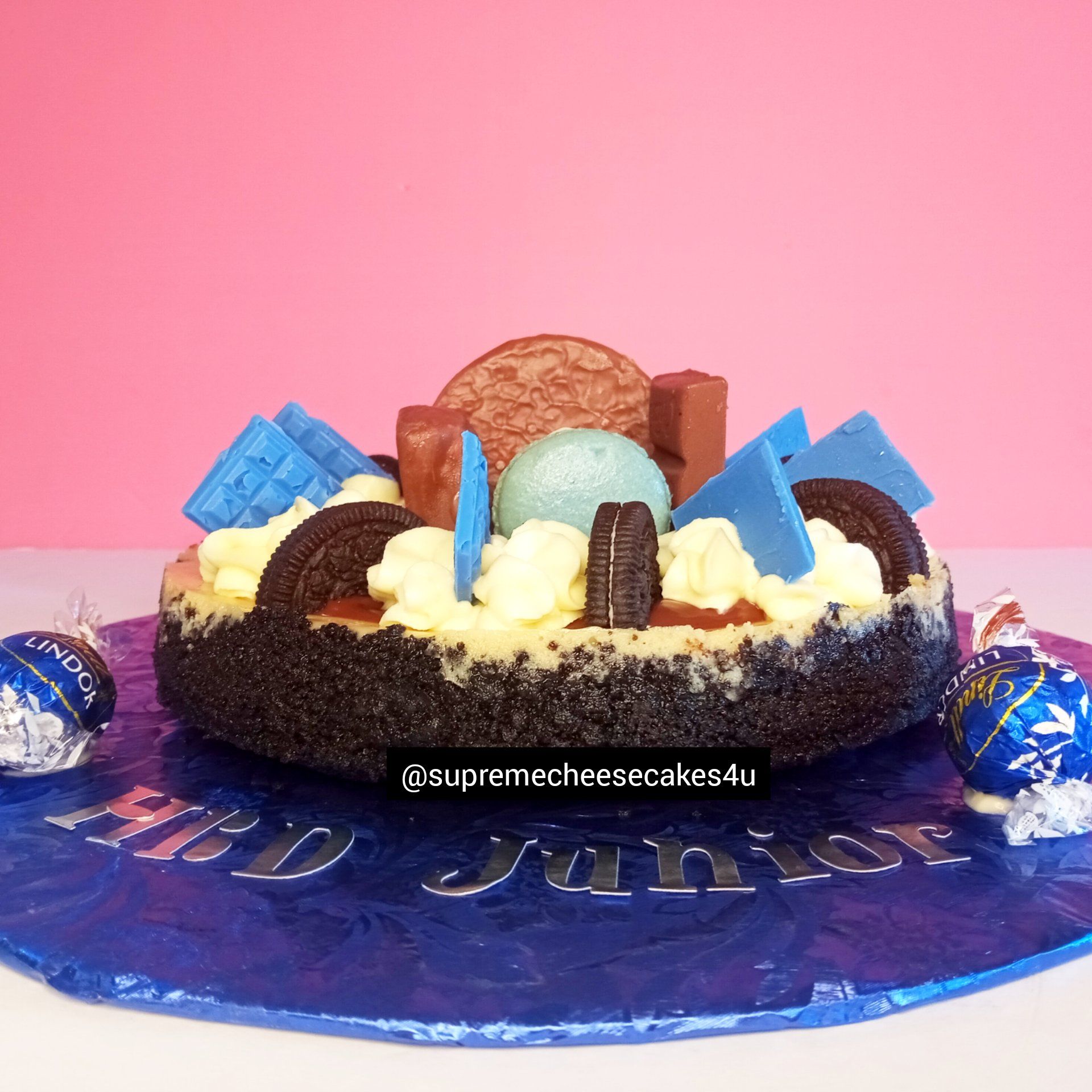 A cake with oreos and whipped cream on top of it