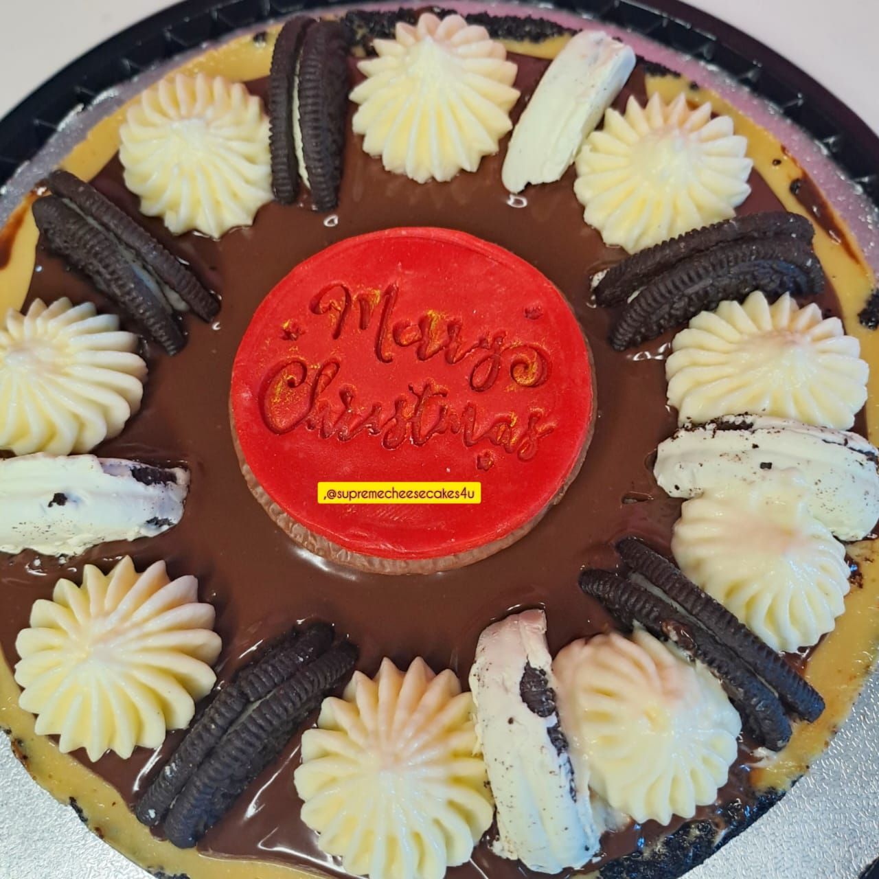 A christmas cake with oreos and whipped cream on it