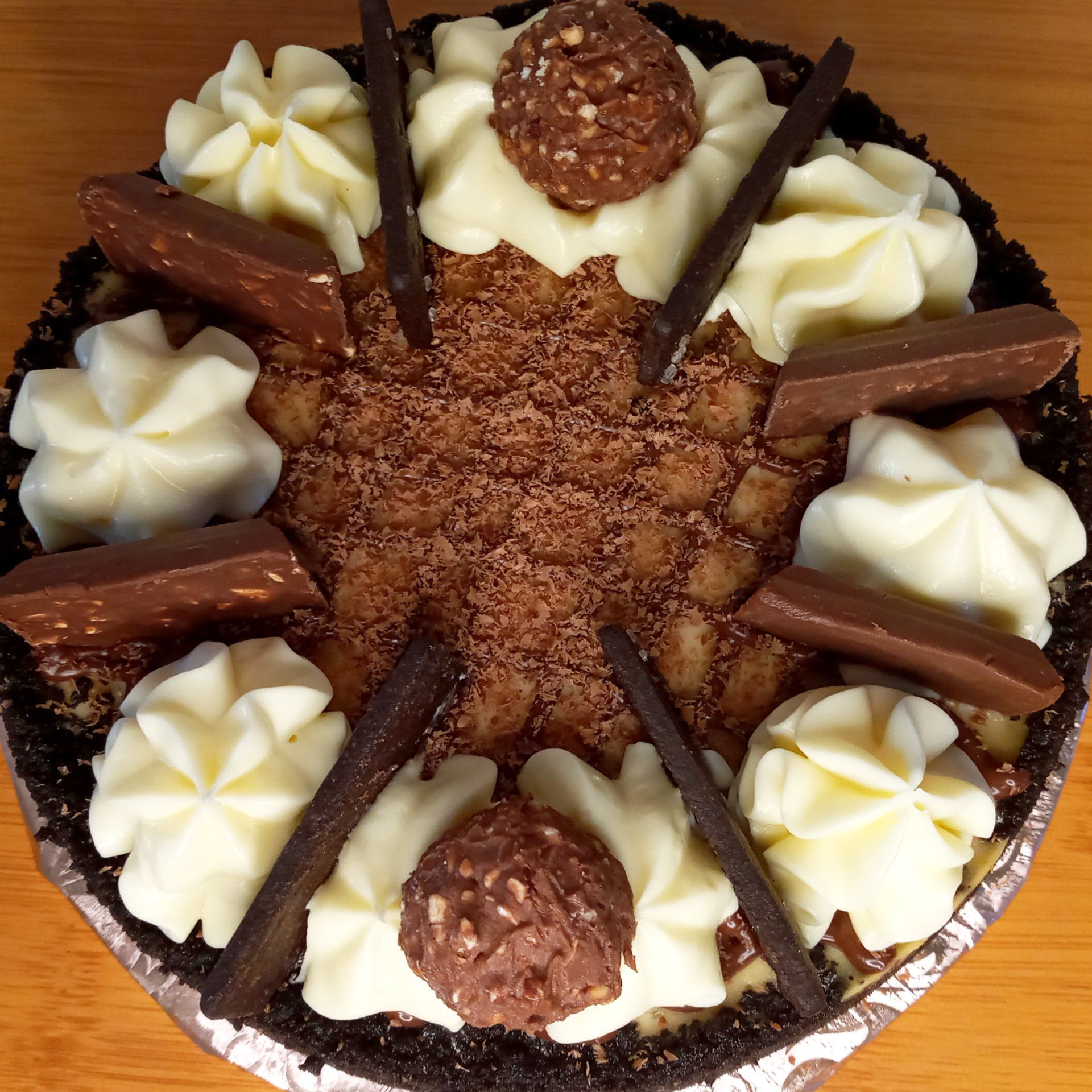 A pie with chocolate and whipped cream on top