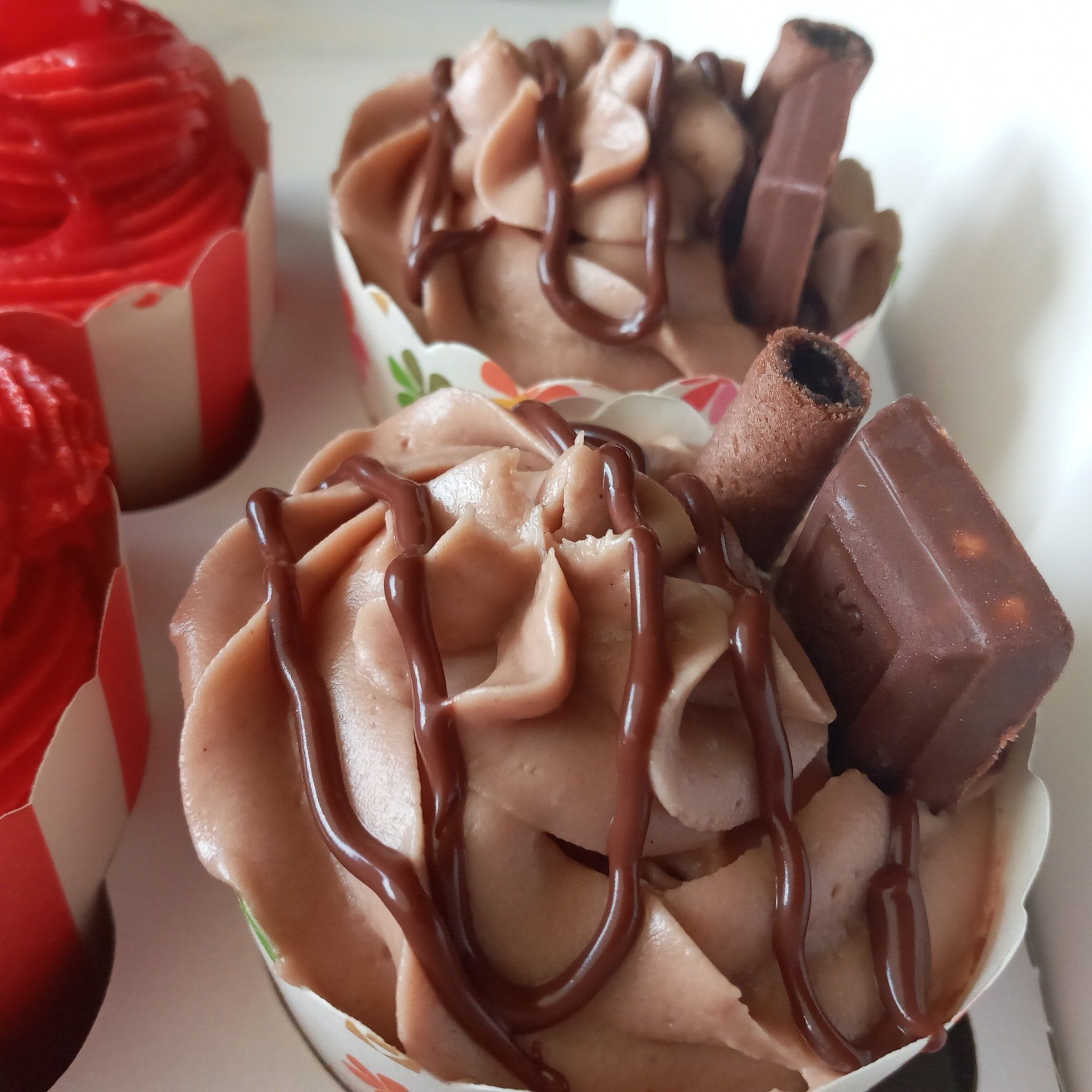 A close up of a cupcake with chocolate frosting