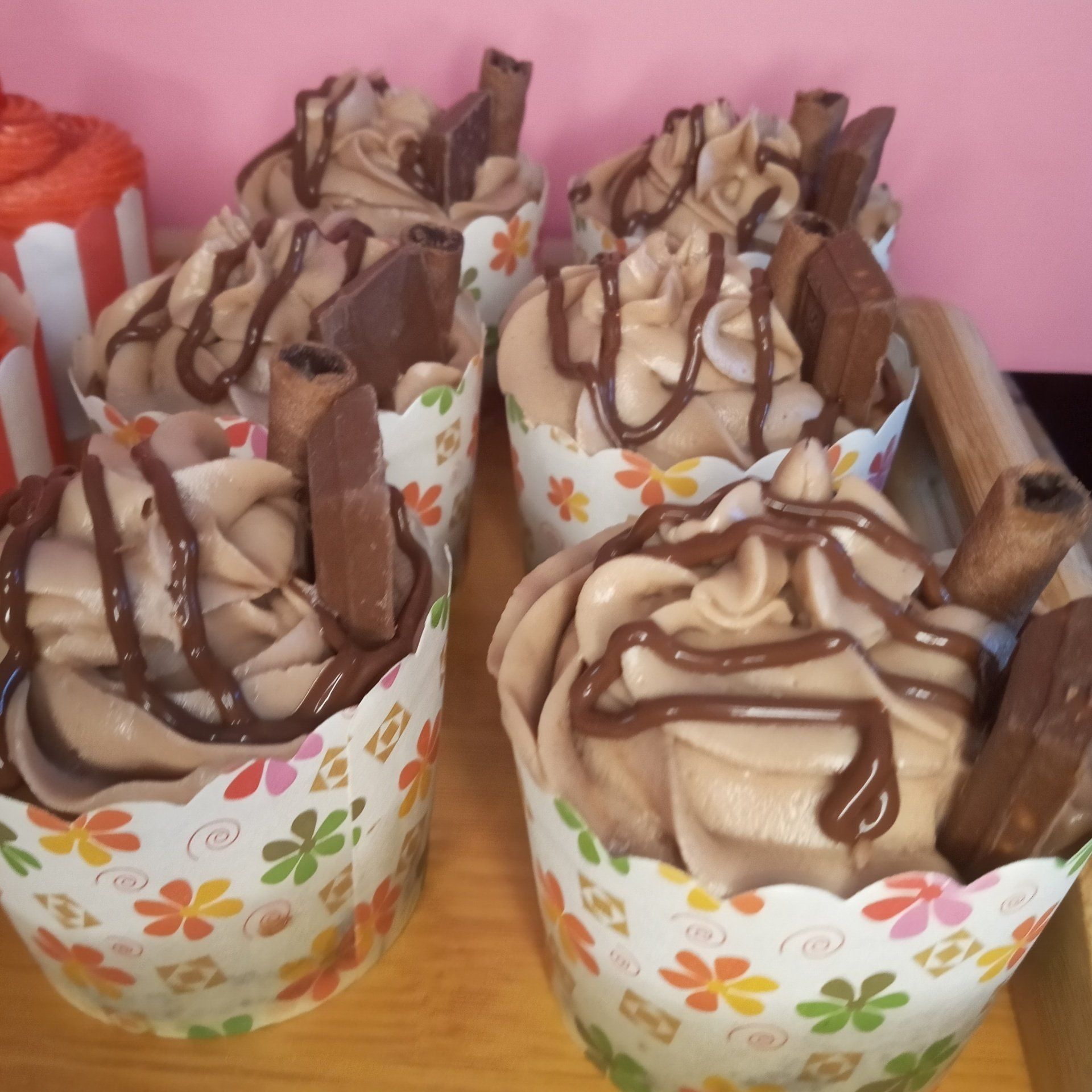 A bunch of cupcakes with chocolate frosting on them