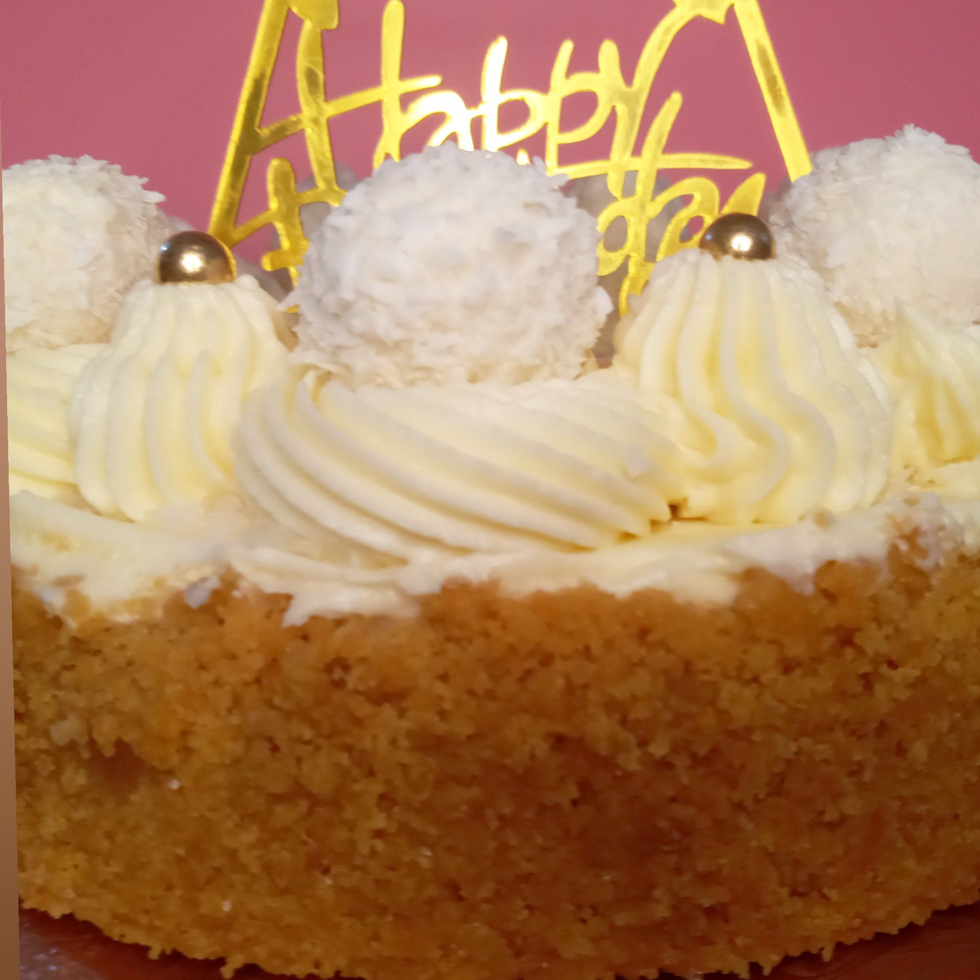 A close up of a cake with a happy birthday topper