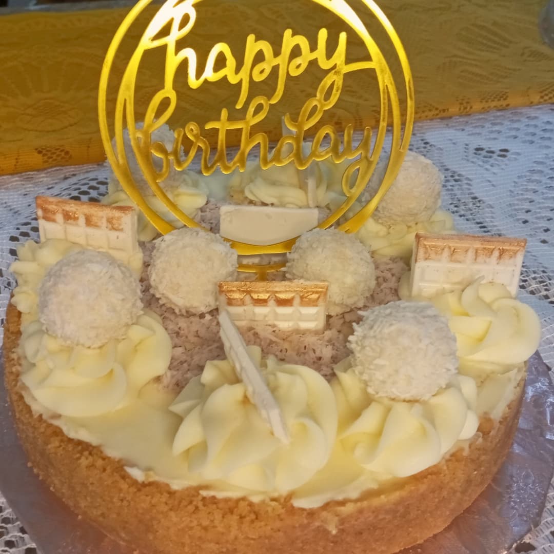 A cake with a happy birthday topper on top