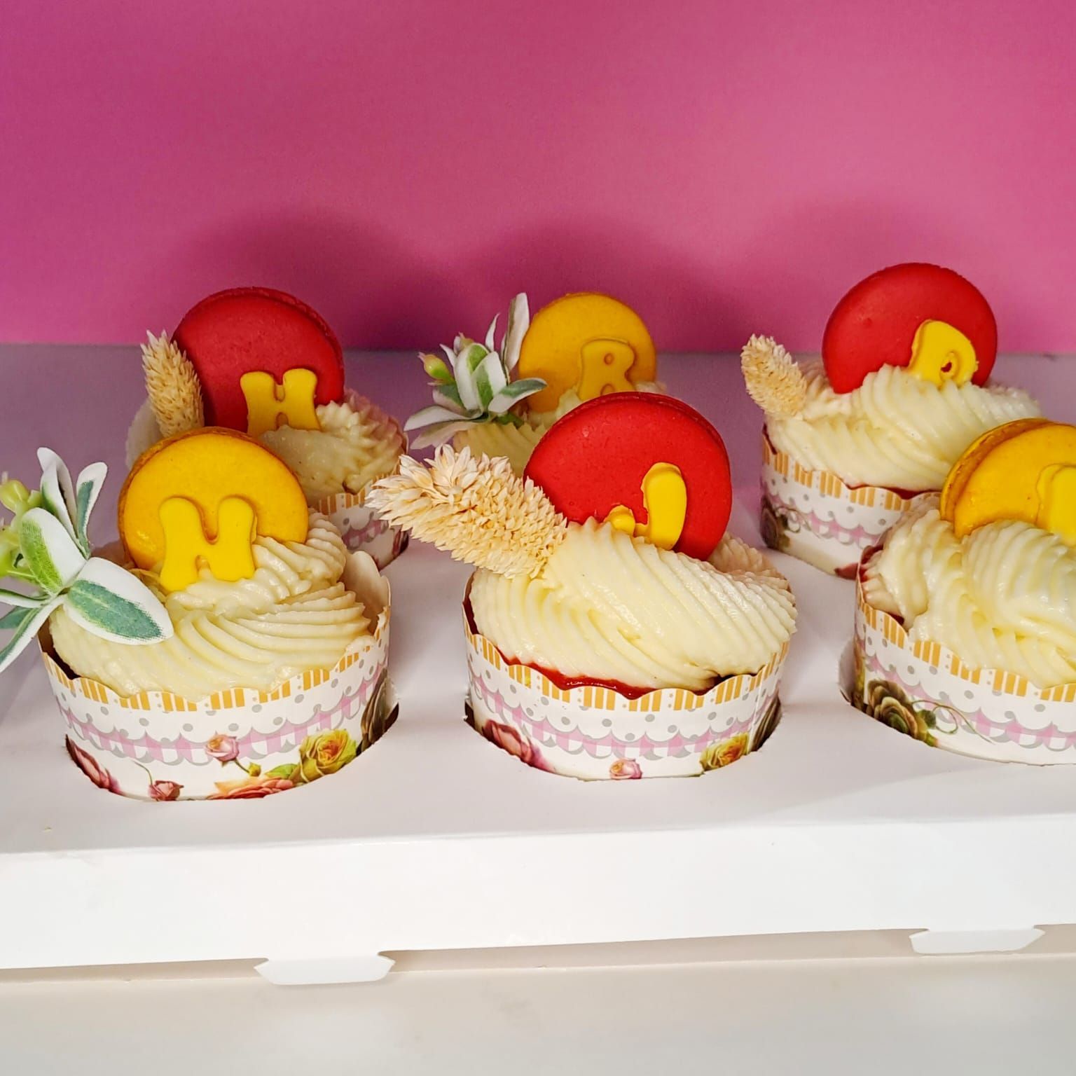 A tray of cupcakes with the letter h on them