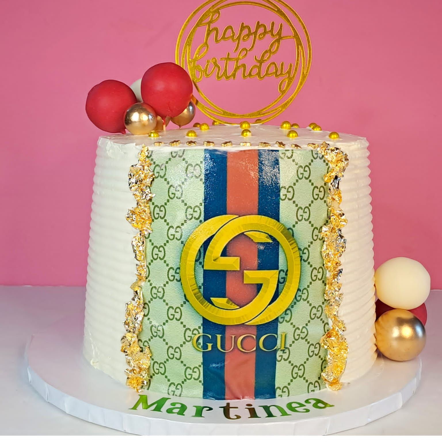 A birthday cake with a gucci logo on it